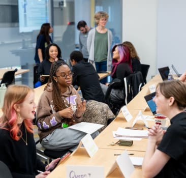 MD HIRES students and faculty practicing their “elevator pitches” about their research
