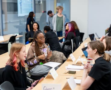 MD HIRES students and faculty practicing their “elevator pitches” about their research